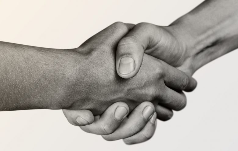 Business agreement handshake on white background. Black Business agreement handshake on white background. Black